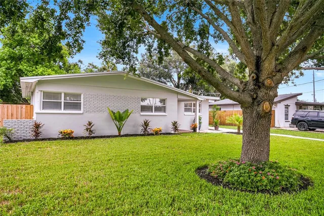 a kitchen with granite countertop white cabinets and stainless steel appliances
