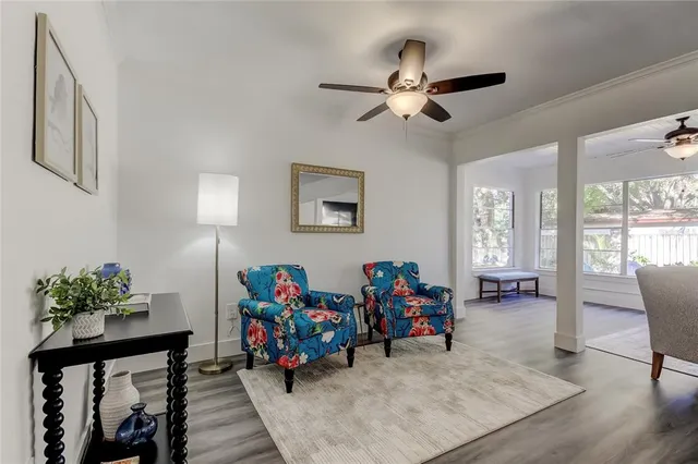 an empty room with wooden floor a ceiling fan and closet