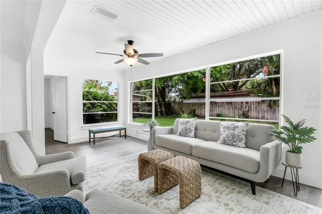 a view of a dining room with furniture wooden floor and windows