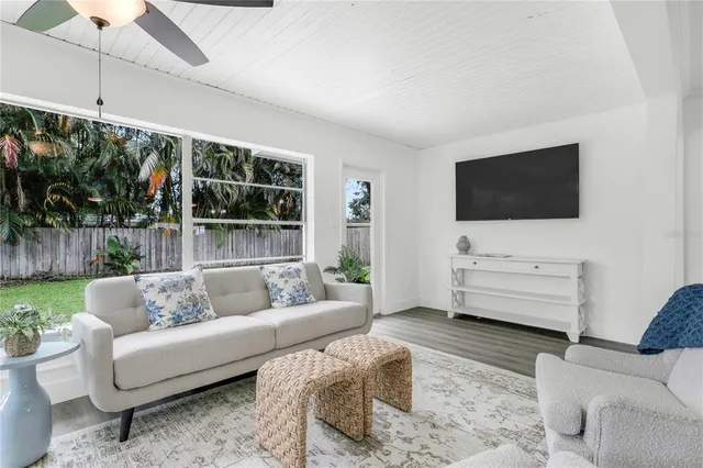 a view of a dining room with furniture a chandelier and wooden floor