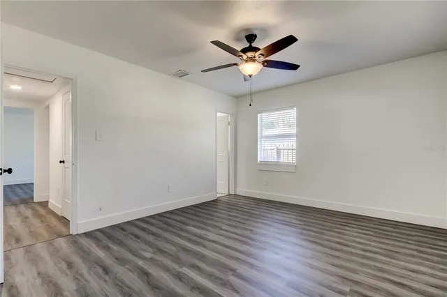 a front view of house with a garden and trees