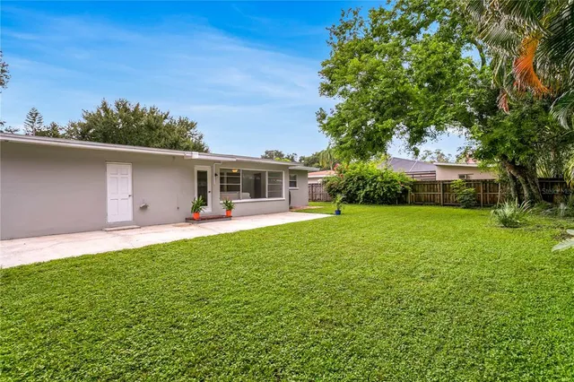 a kitchen with granite countertop white cabinets white stainless steel appliances and a sink