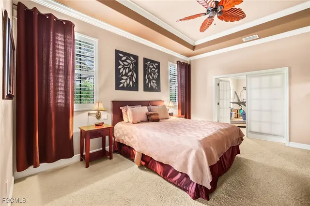 a spacious bedroom with a bed and a chandelier