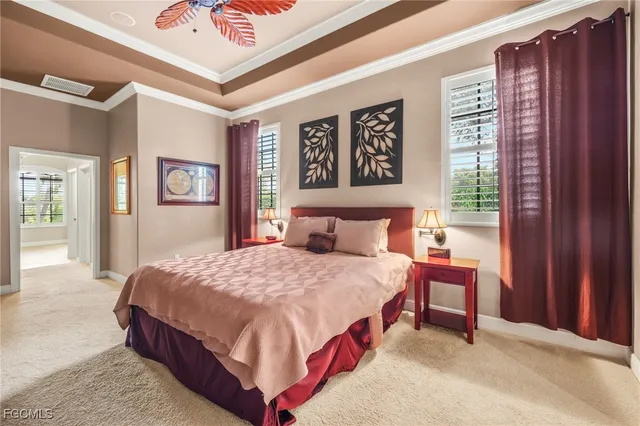 a bedroom with a bed lamp and a window