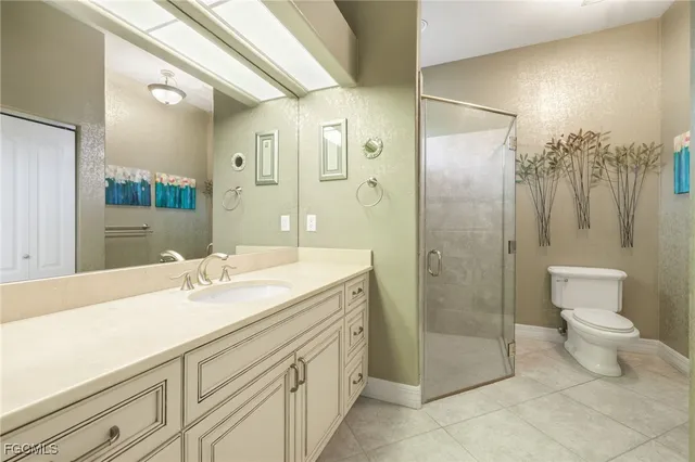a spacious bathroom with a shower sink mirror and toilet