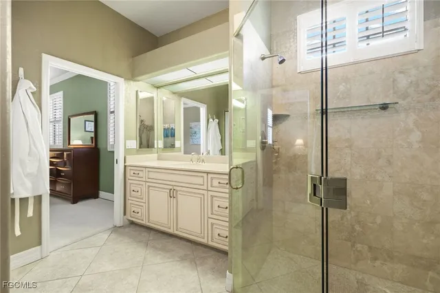 a bathroom with a granite countertop sink mirror and shower