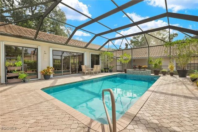 a view of a patio with a table and chairs under an umbrella
