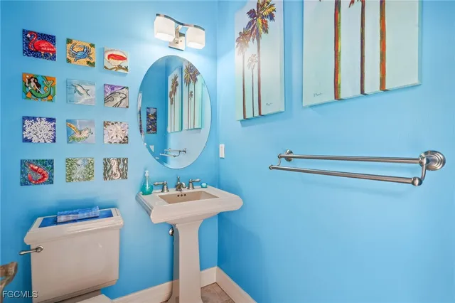 a bathroom with a sink a mirror and toilet