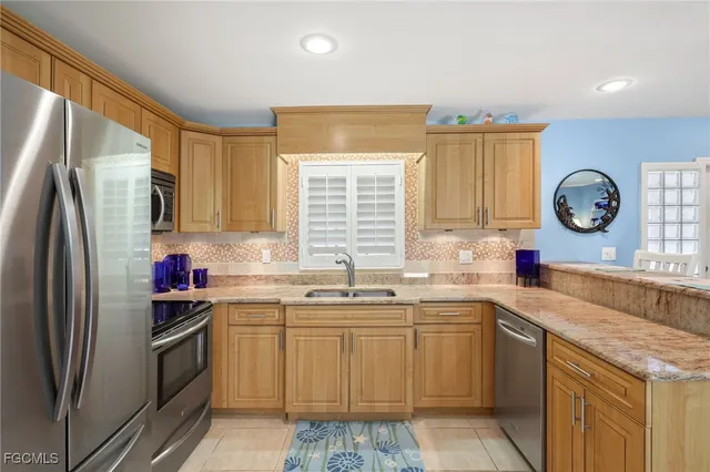a kitchen with a sink stove and refrigerator