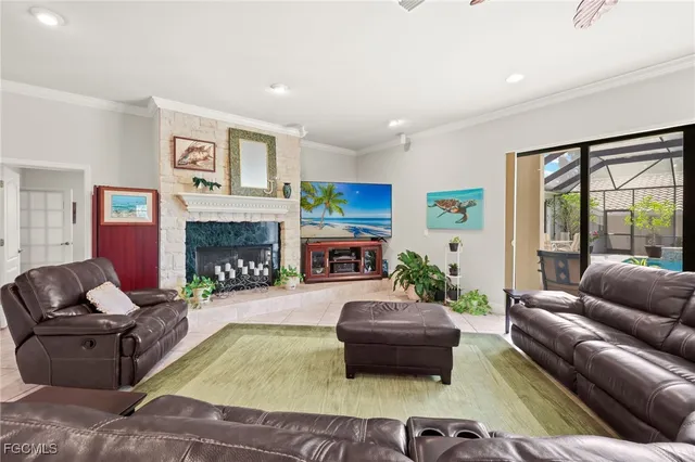 a living room with furniture fireplace and a large window