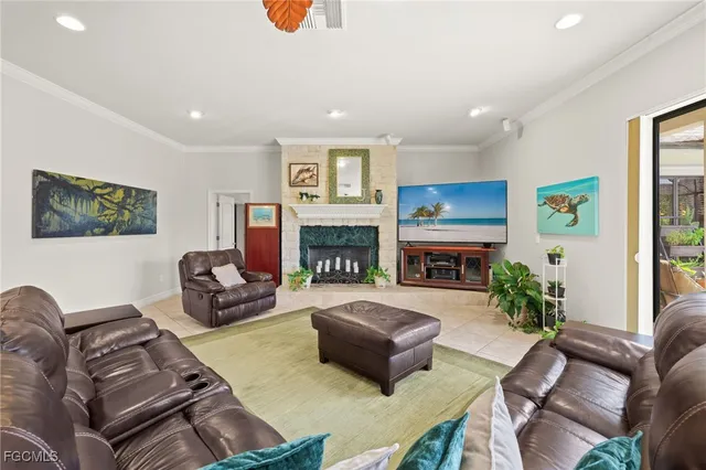 a living room with furniture flat screen tv and a fireplace