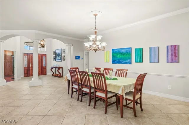 a view of a dining room with furniture and chandelier