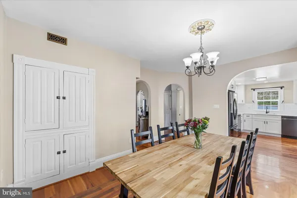 a view of a dining room with furniture and wooden floor