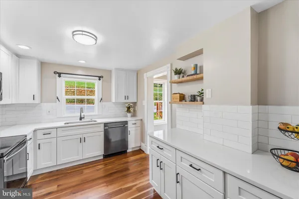 a large kitchen with cabinets and window