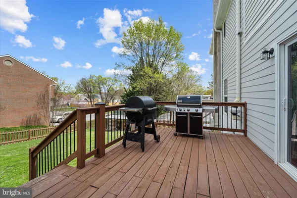 a view of a balcony with furniture and wooden floor