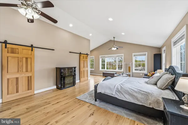 a spacious bedroom with a large bed and a fireplace