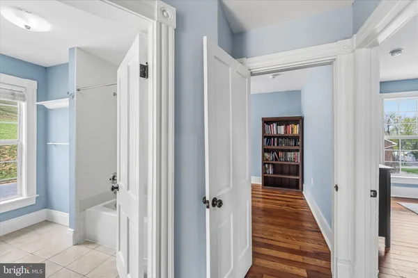a view of a hallway with wooden floor and entryway