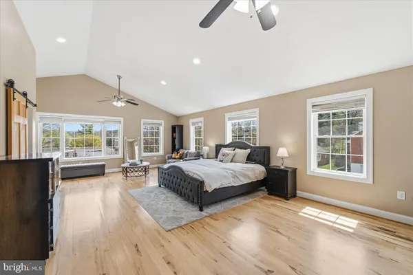 a spacious bedroom with a large bed and a large window