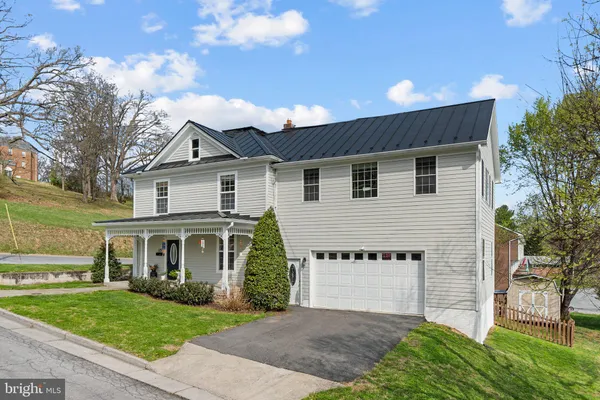 a front view of a house with a garden