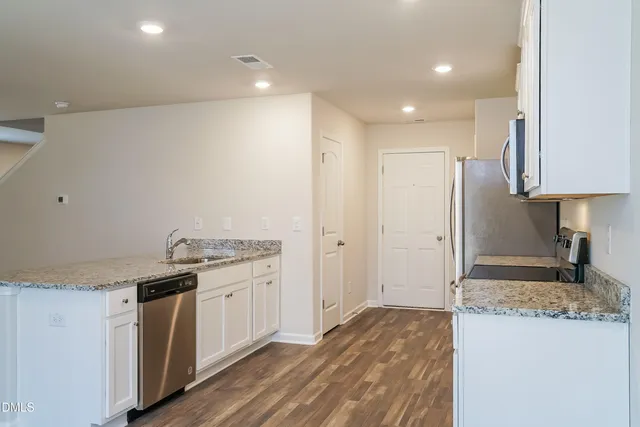 a kitchen with a sink stove and refrigerator
