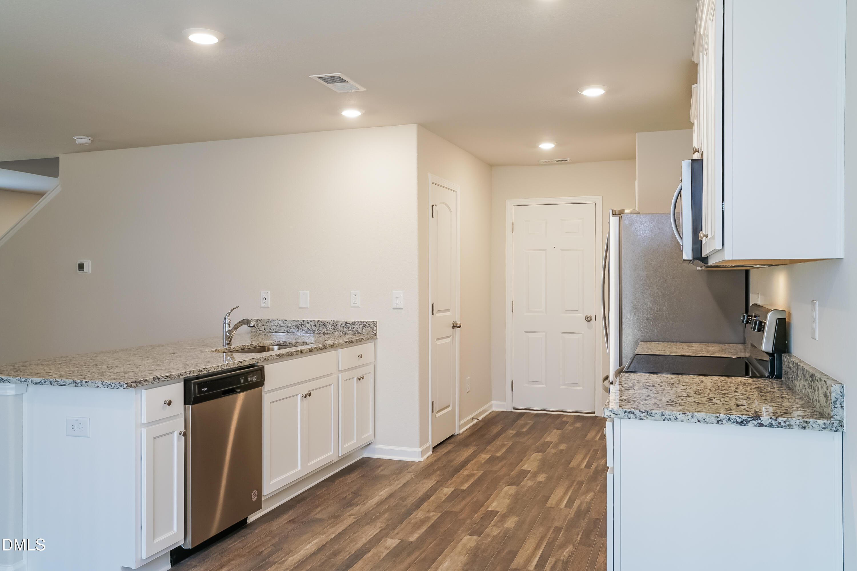 541 Gusty Lane Zebulon, NC 27597 - Photo 6 of 17 a kitchen with a sink stove and refrigerator