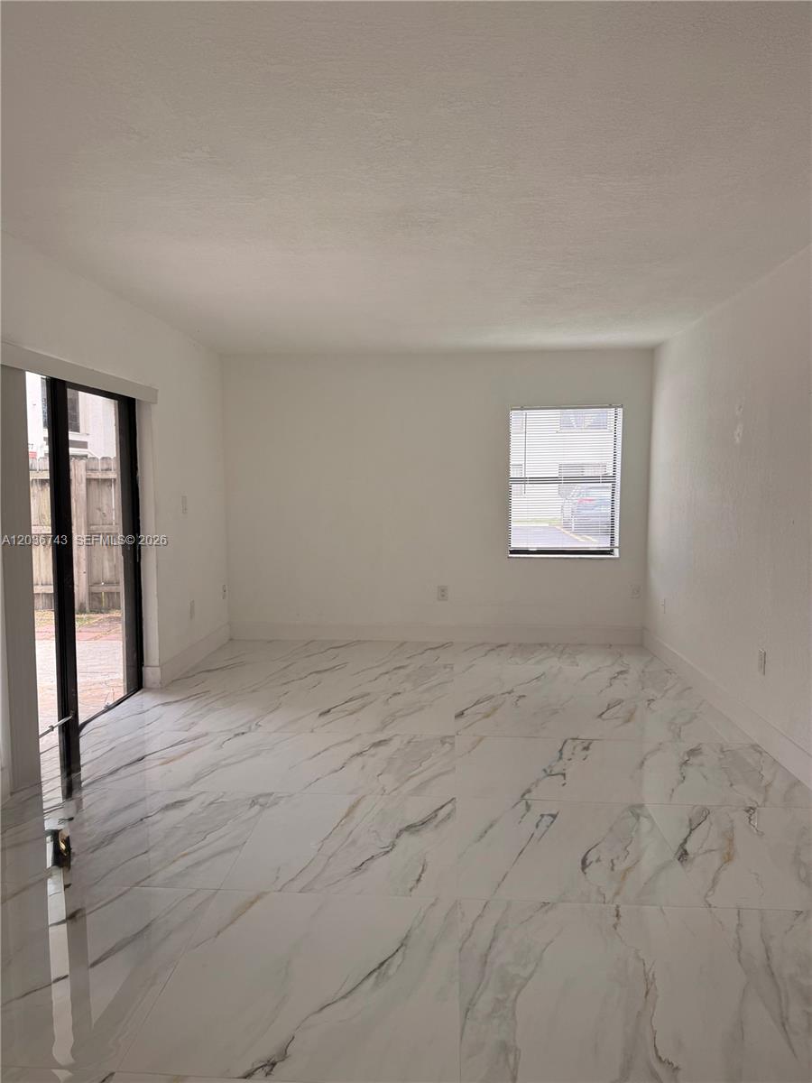 10875 Northwest 7th Street, Unit 1136 Miami, FL 33172 - Photo 5 of 25 an empty room with windows