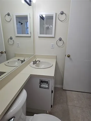 a bathroom with a sink a toilet and mirror