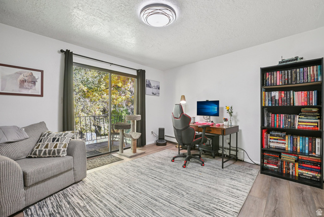 645 Swenson Avenue, Unit 3 Springville, UT 84663 - Photo 7 of 9 Office space with a textured ceiling, light wood-style flooring, and baseboard heating