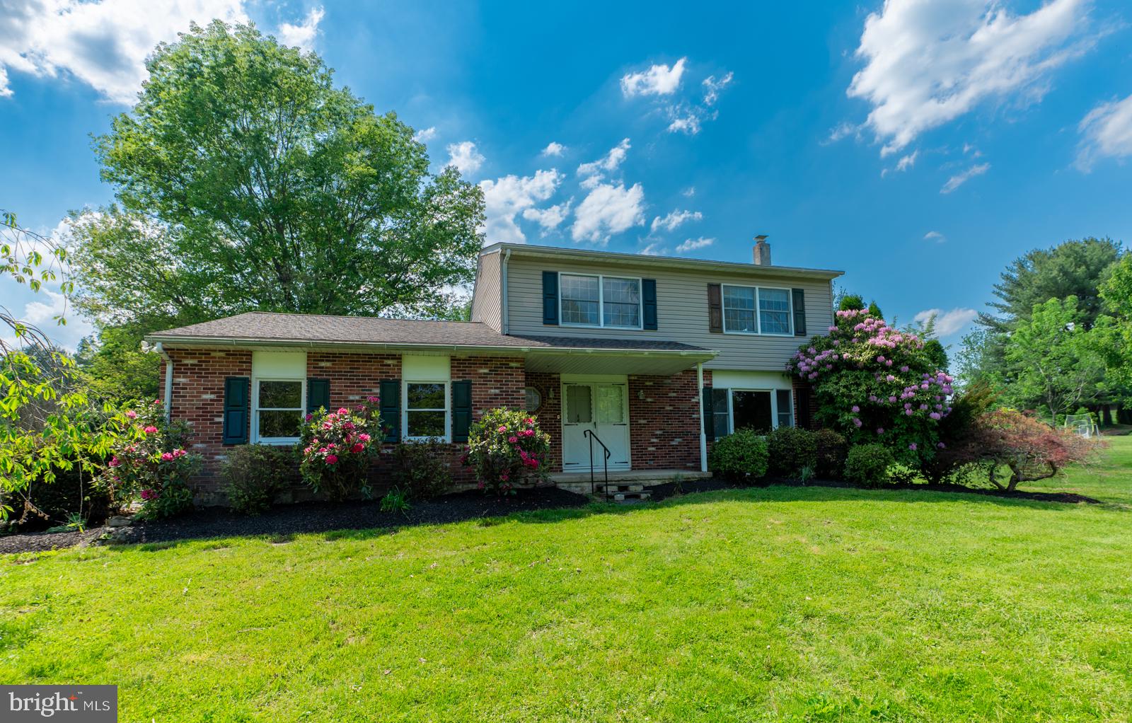223 Trythall Road Elverson, PA 19520 - Photo 2 of 78 a front view of a house with garden