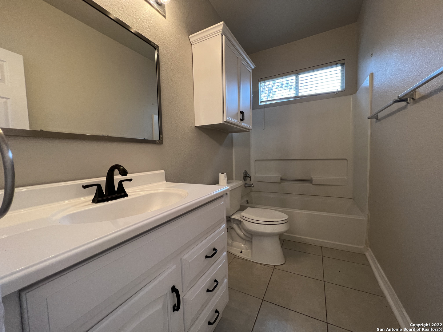 7047 Tourant Road San Antonio, TX 78240 - Photo 12 of 13 a bathroom with a toilet a sink and mirror