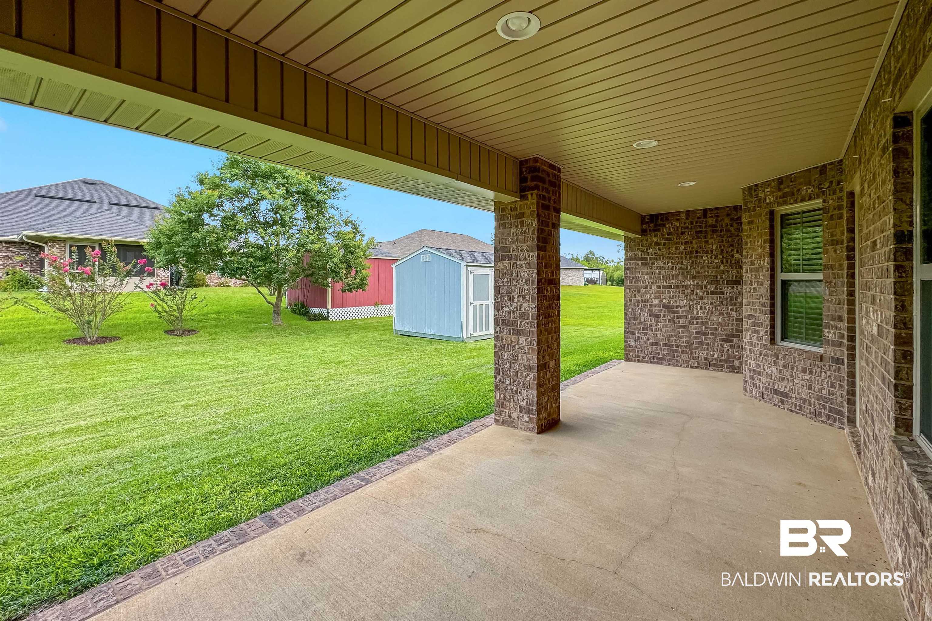 13155 Wishbone Court Foley, AL 36535 - Photo 34 of 39 View of patio featuring a storage unit