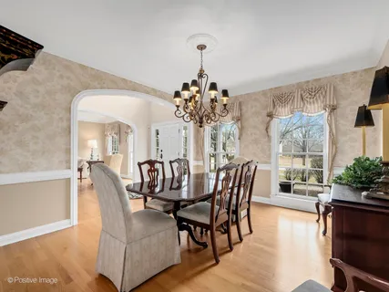 a dining room with furniture potted plants and wooden floor