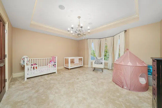 a view of a patio with couches table and chairs with wooden floor and fence