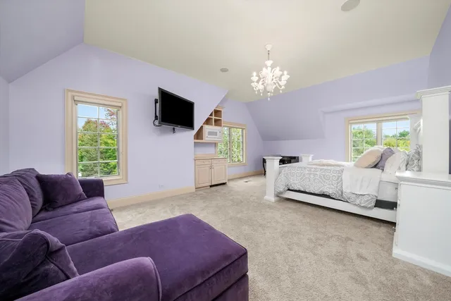 a view of a patio with couches table and chairs with wooden floor and fence