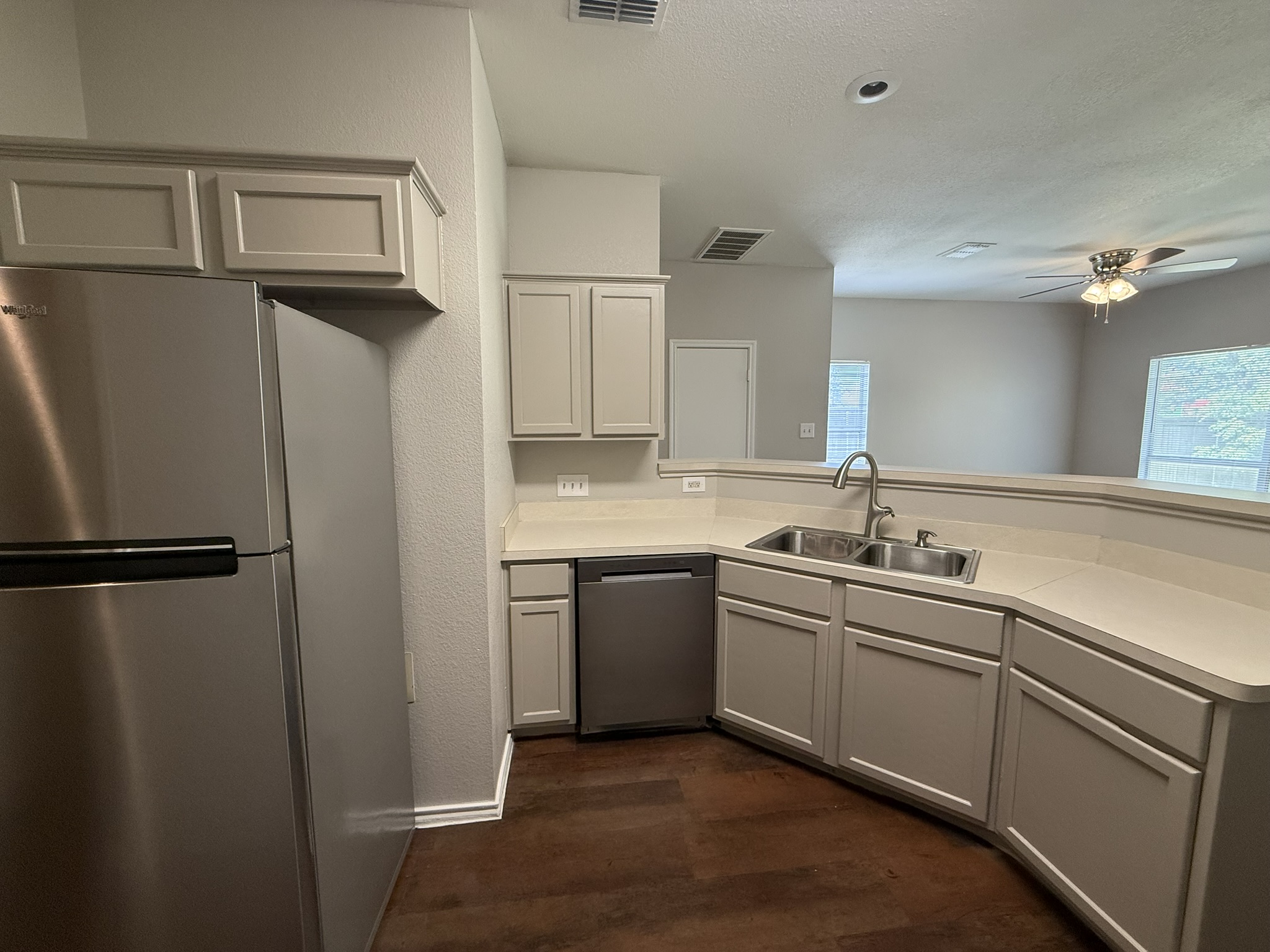 6726 Windrift Way, Unit A Austin, TX 78745 - Photo 11 of 29 a kitchen with stainless steel appliances cabinets a sink and a refrigerator