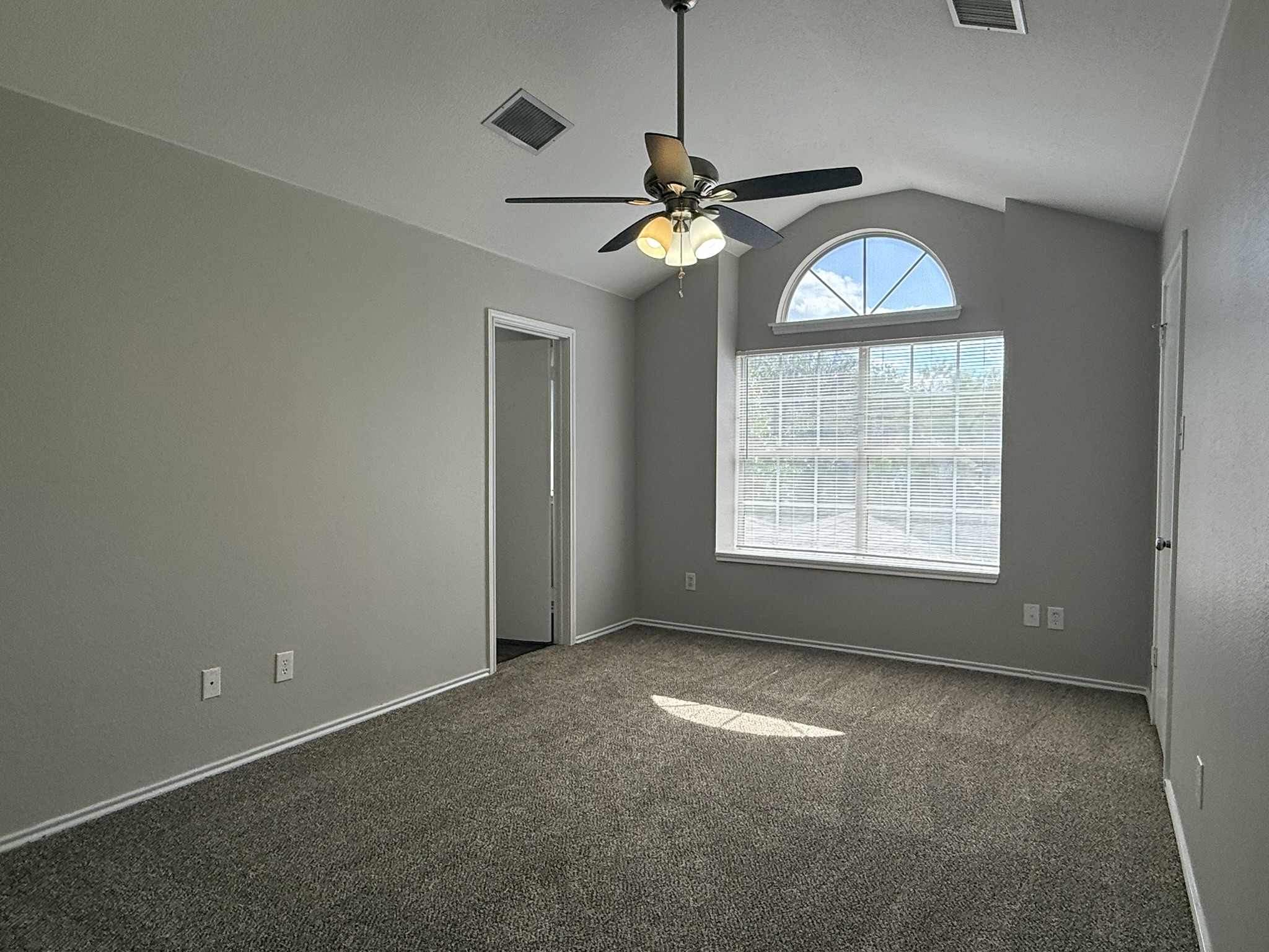 6726 Windrift Way, Unit A Austin, TX 78745 - Photo 16 of 29 an empty room with windows and fan