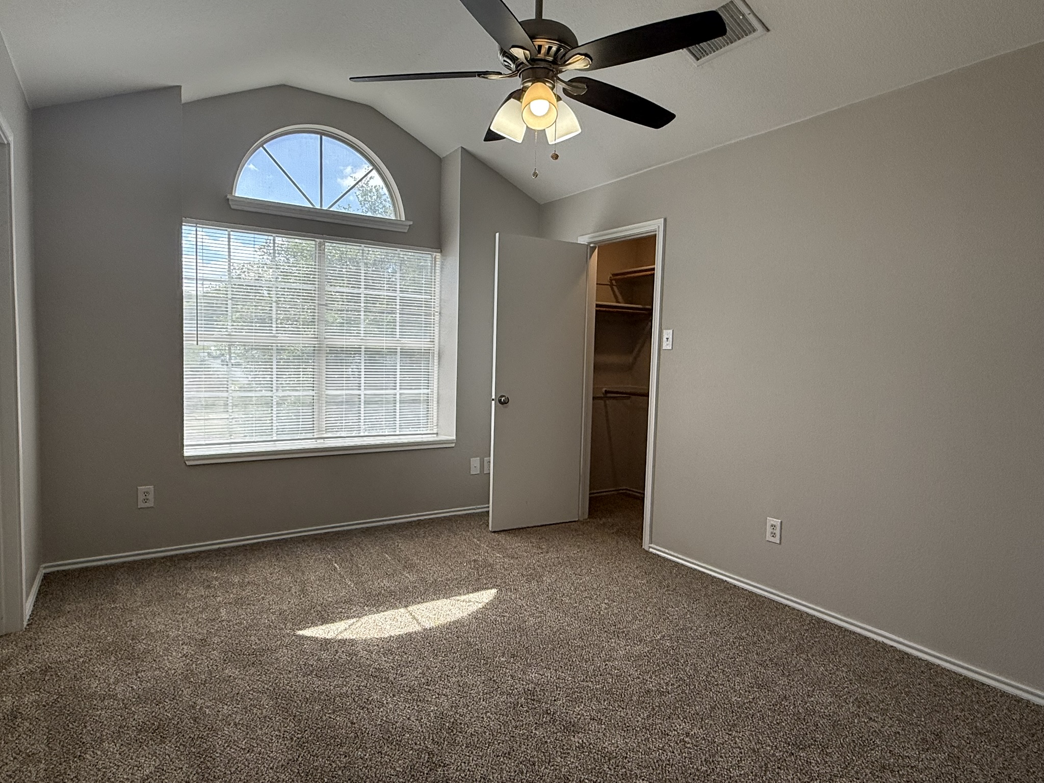 6726 Windrift Way, Unit A Austin, TX 78745 - Photo 18 of 29 an empty room with chandelier fan and windows