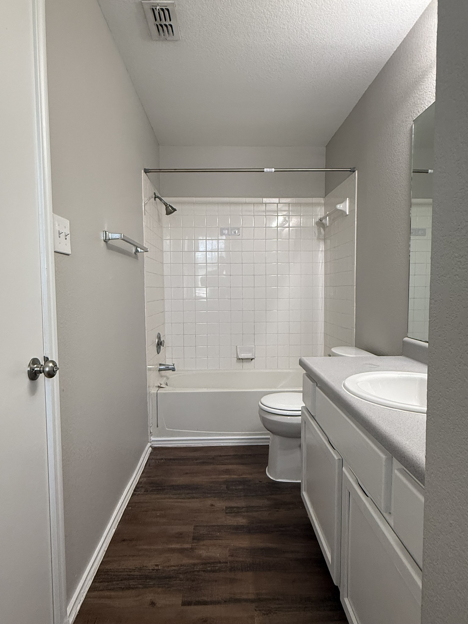 6726 Windrift Way, Unit A Austin, TX 78745 - Photo 22 of 29 a bathroom with a granite countertop toilet a sink and a shower