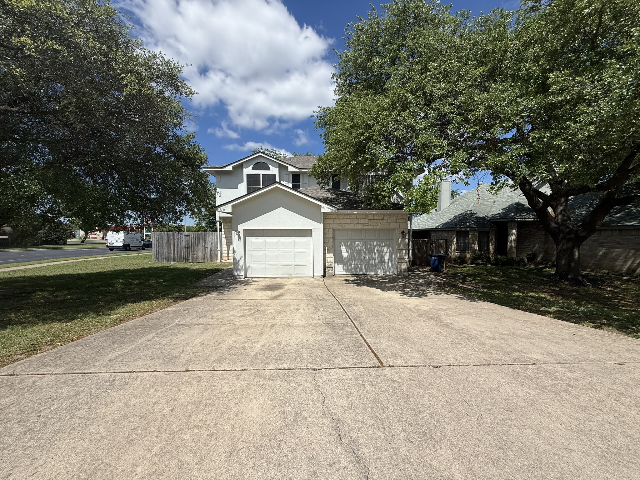 6726 Windrift Way, Unit A Austin, TX 78745 - Photo 3 of 29 a front view of a house with a yard and garage
