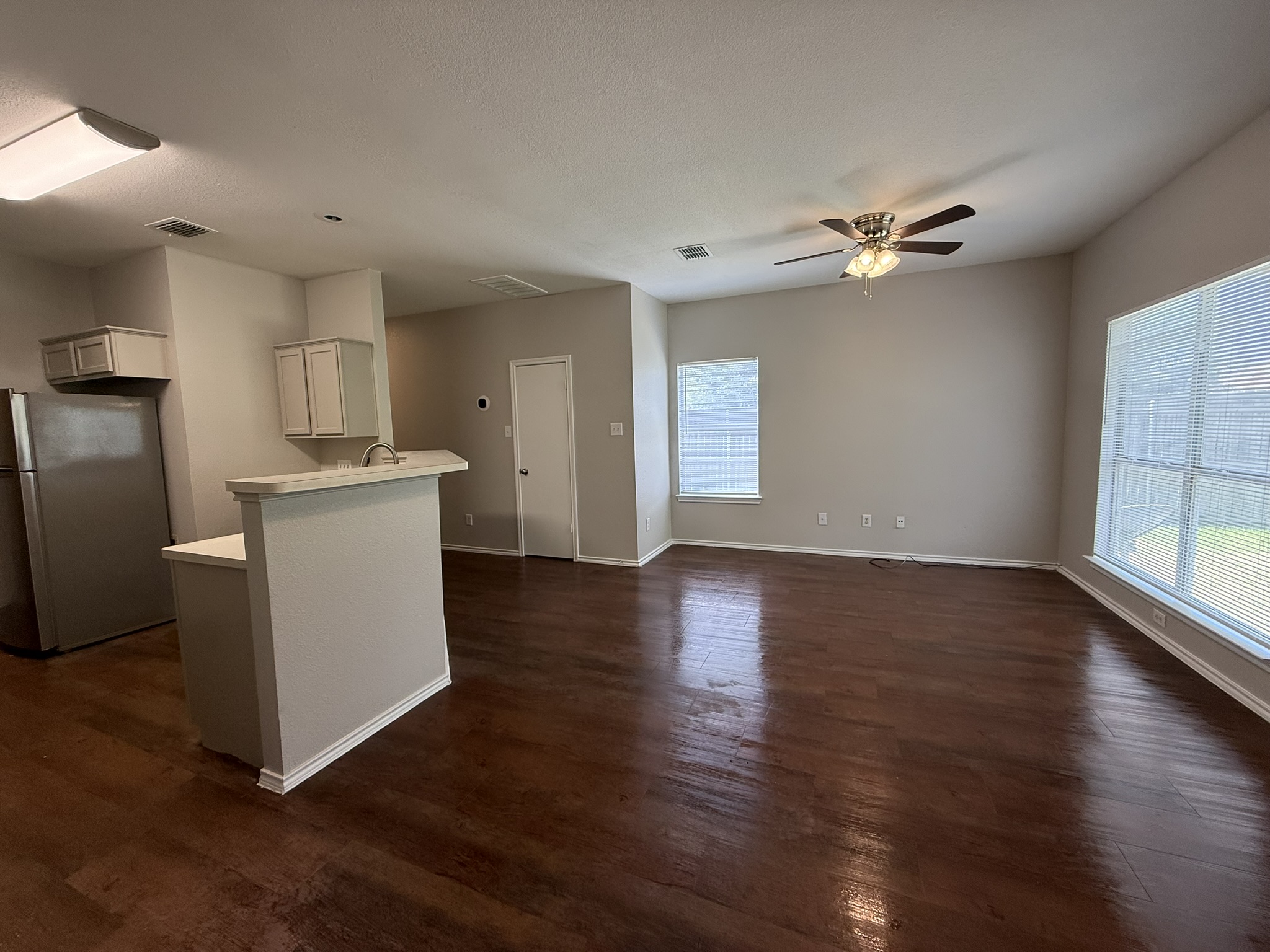 6726 Windrift Way, Unit A Austin, TX 78745 - Photo 29 of 29 a view of a kitchen with wooden floor and a ceiling fan