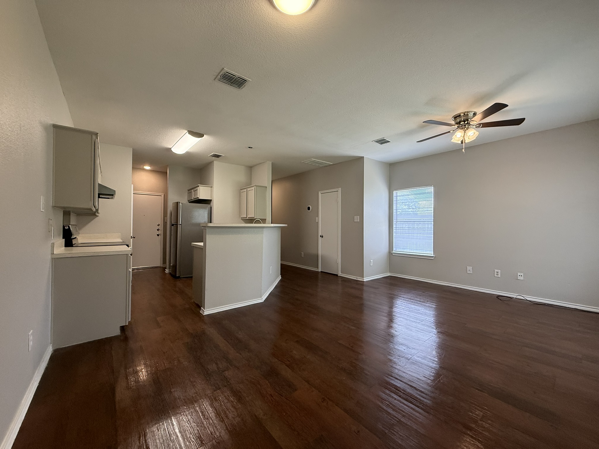6726 Windrift Way, Unit A Austin, TX 78745 - Photo 6 of 29 a view of a kitchen with a sink a microwave and a refrigerator