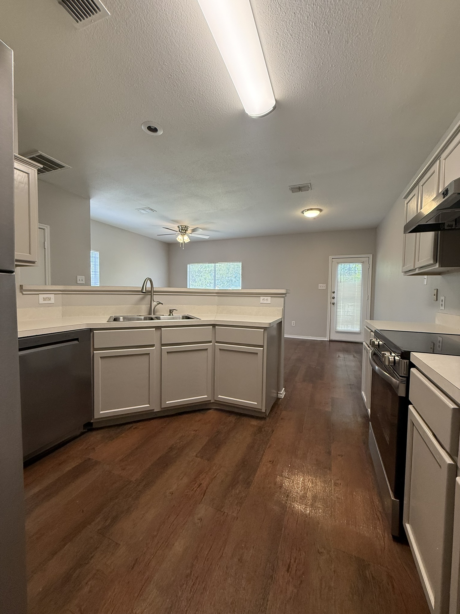 6726 Windrift Way, Unit A Austin, TX 78745 - Photo 9 of 29 a kitchen with a sink cabinets stainless steel appliances and a window