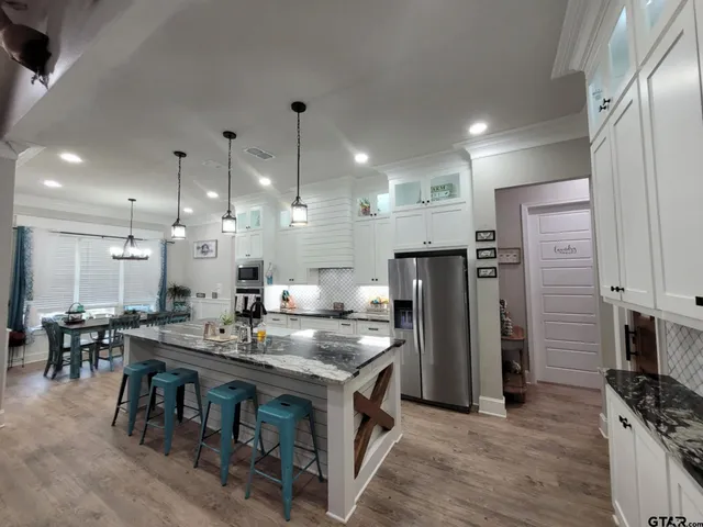 a spacious bathroom with a granite countertop sink and mirror