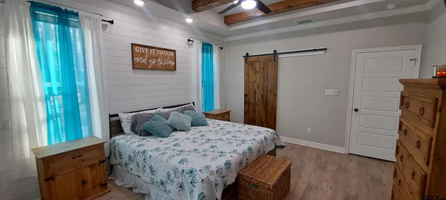 a bathroom with a granite countertop sink a mirror and a shower