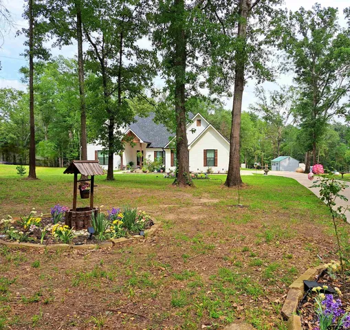 a front view of a house with garden and porch