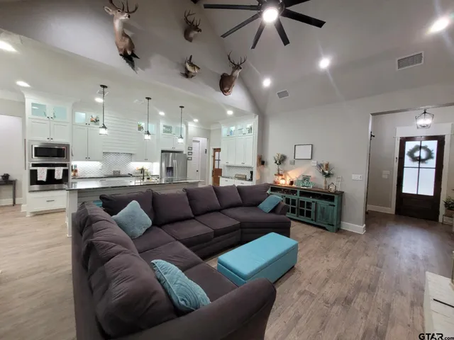 a living room with furniture a fireplace and a chandelier