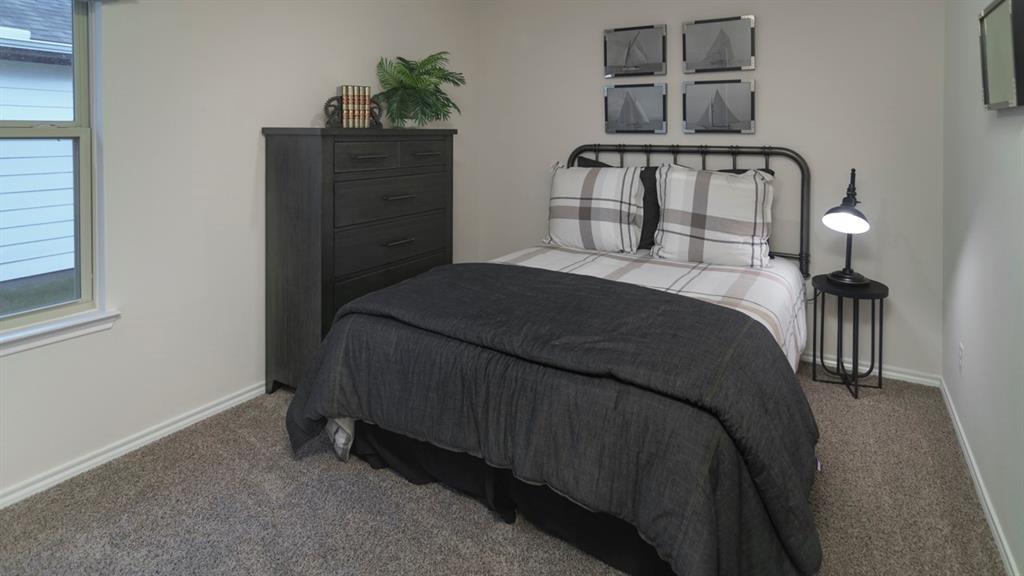 3100 Charleston Drive Ennis, TX 75119 - Photo 7 of 23 Carpeted room with a double-paned window, neutral wall paint, and white trim