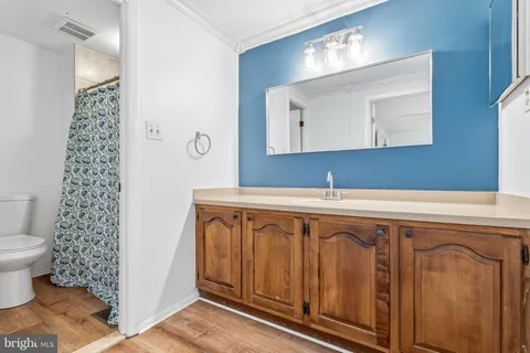 a bathroom with a toilet and a shower curtain