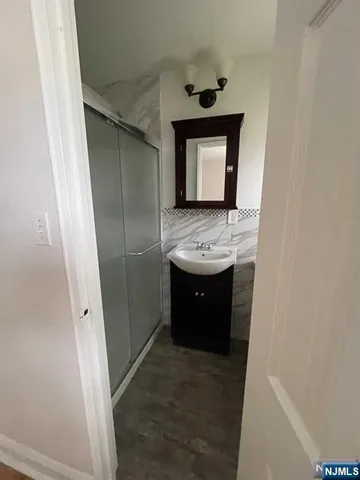 a bathroom with a sink a toilet a mirror and window