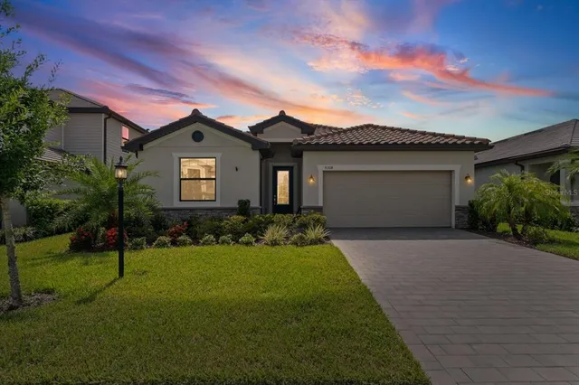 a front view of a house with a yard and garage